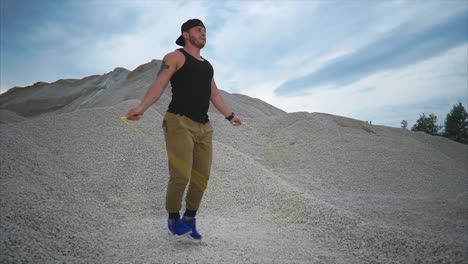 man jumping rope in a quarry