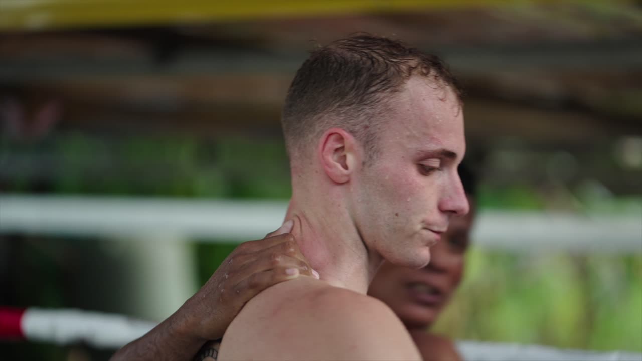 Muay Thai Athlete Hydrating and Receiving Coaching Support During Training
