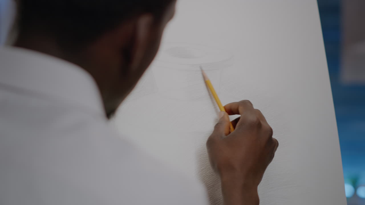 Close up of african american young artist using hand with pencil