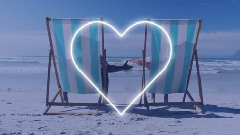 animation of african american couple lying at beach over heart