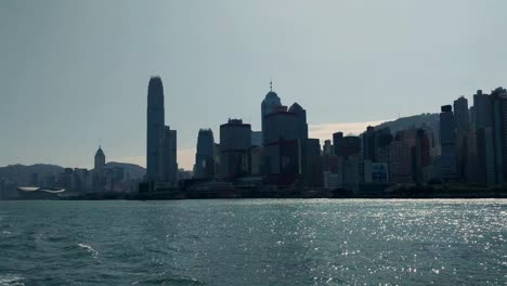 Hong-Kong-island-skyline-during-the-day,-view-from-boat-on-Victoria-Harbor