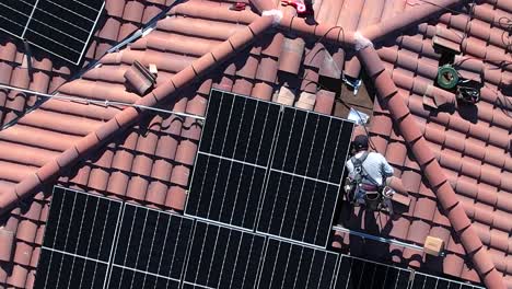 installer working on solar panel, santa clarita house project, aerial rising above, alternative technology