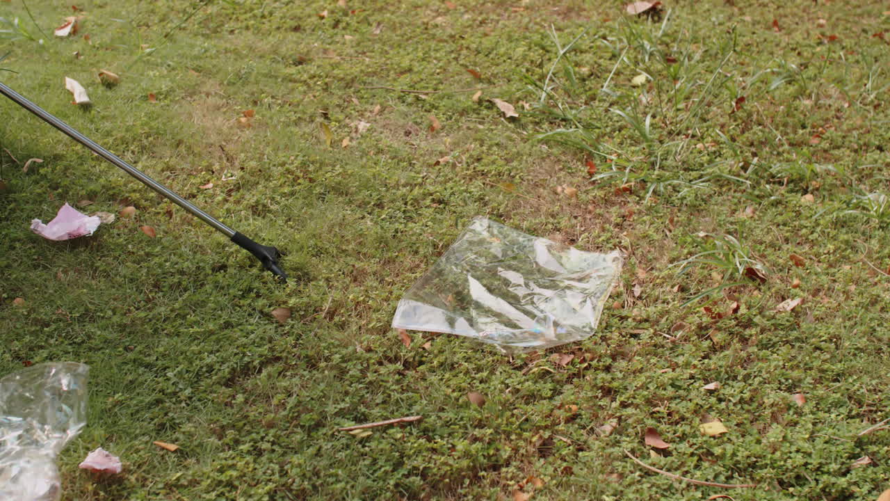 Man Talking to Girlfriend when Picking Litter Together Outdoors