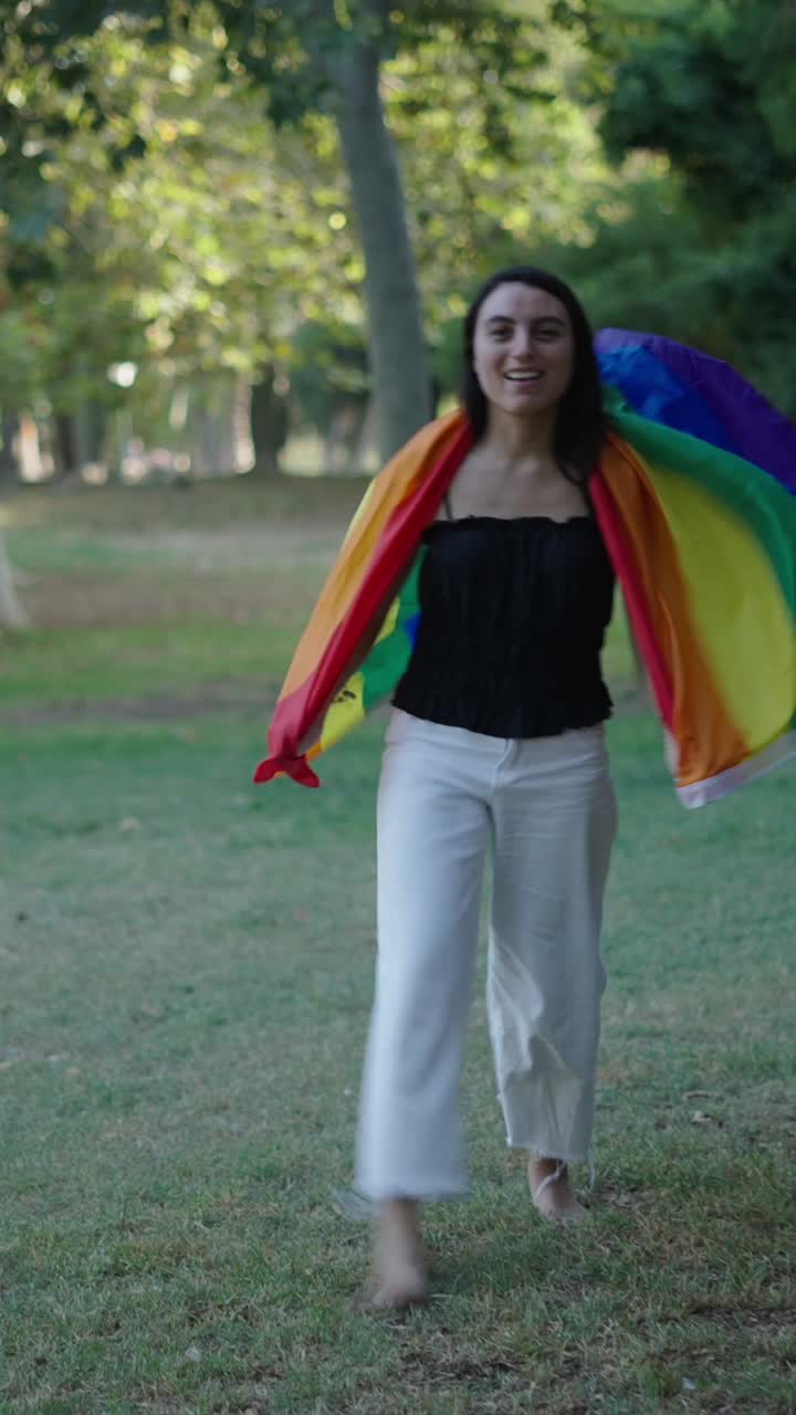 Woman with LGBTQ Pride Flag in Park