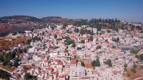 aerial drone view of an old town with traditional architecture and red roofs on a hilly landscape