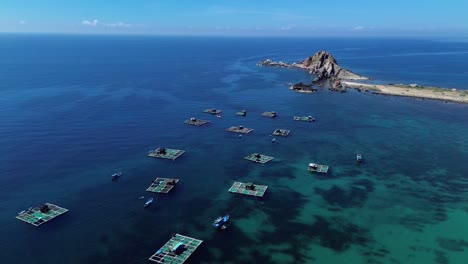 Semi orbit drone shot capturing the fishing village and aquaculture structures in Ninh Hải District, Ninh Thuận, Vietnam.