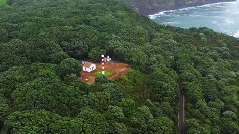 farol da serreta surrounded by lush green trees in azores, terceira island, portugal