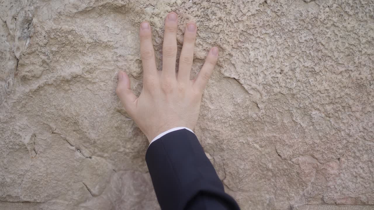 Hand Touching the Western Wall in Jerusalem