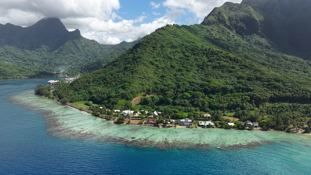 Aerial View of Moorea Island, French Polynesia. Coastal Road, Coral Reefs and Green Hills Above Port