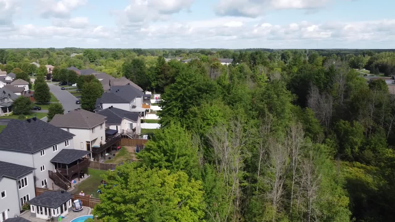 Drone rises over a bike path next to a suburban neighborhood.