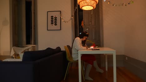 woman writing at home in the evening