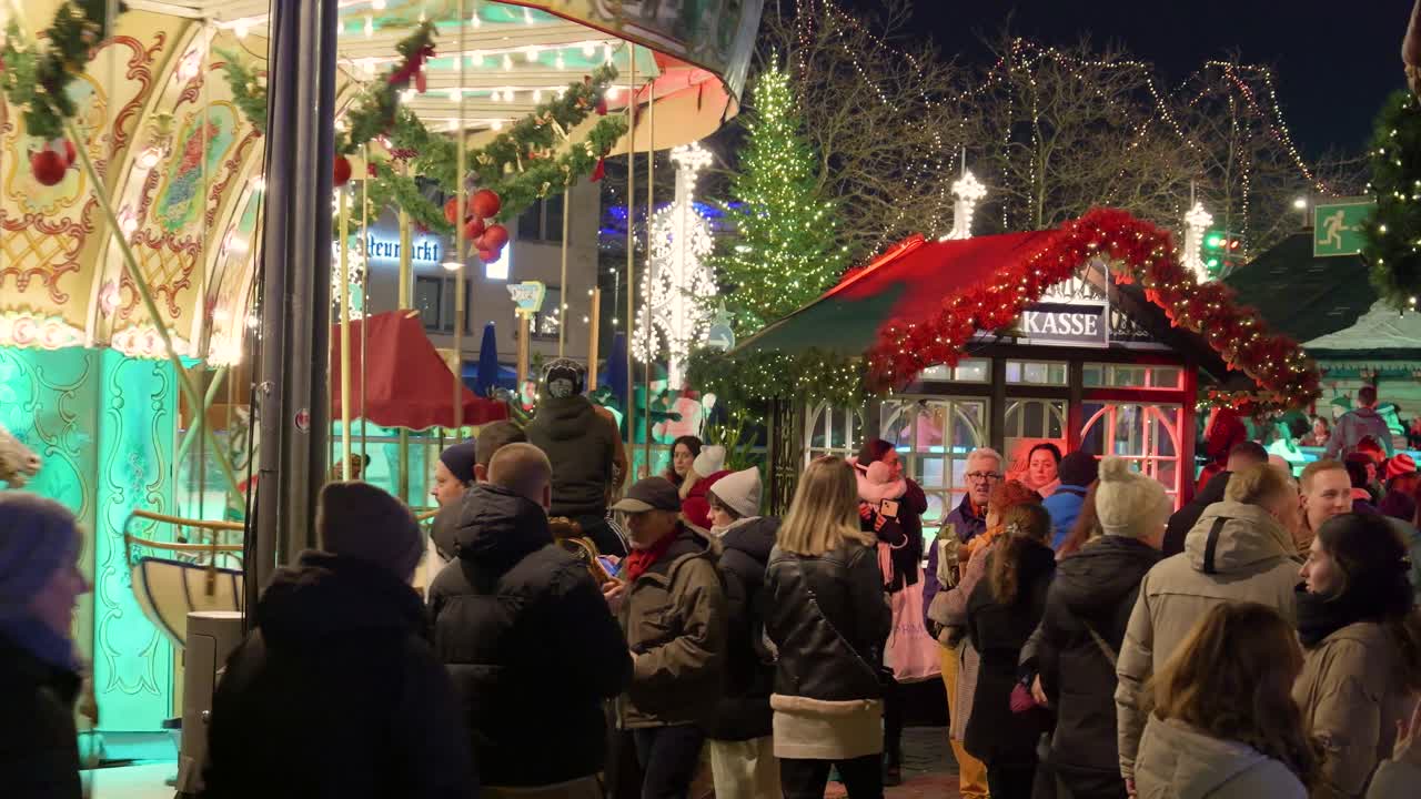 Joulumarkkinatunnelmaa karusellin ja yleisön kanssa yöllä