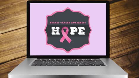 Animation-of-pink-ribbon-logo-and-breast-cancer-text-on-laptop-screen