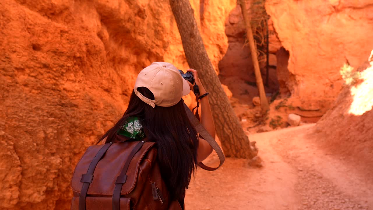 Woman Photographer Hiking and Taking Pictures in a Red Rock Canyon