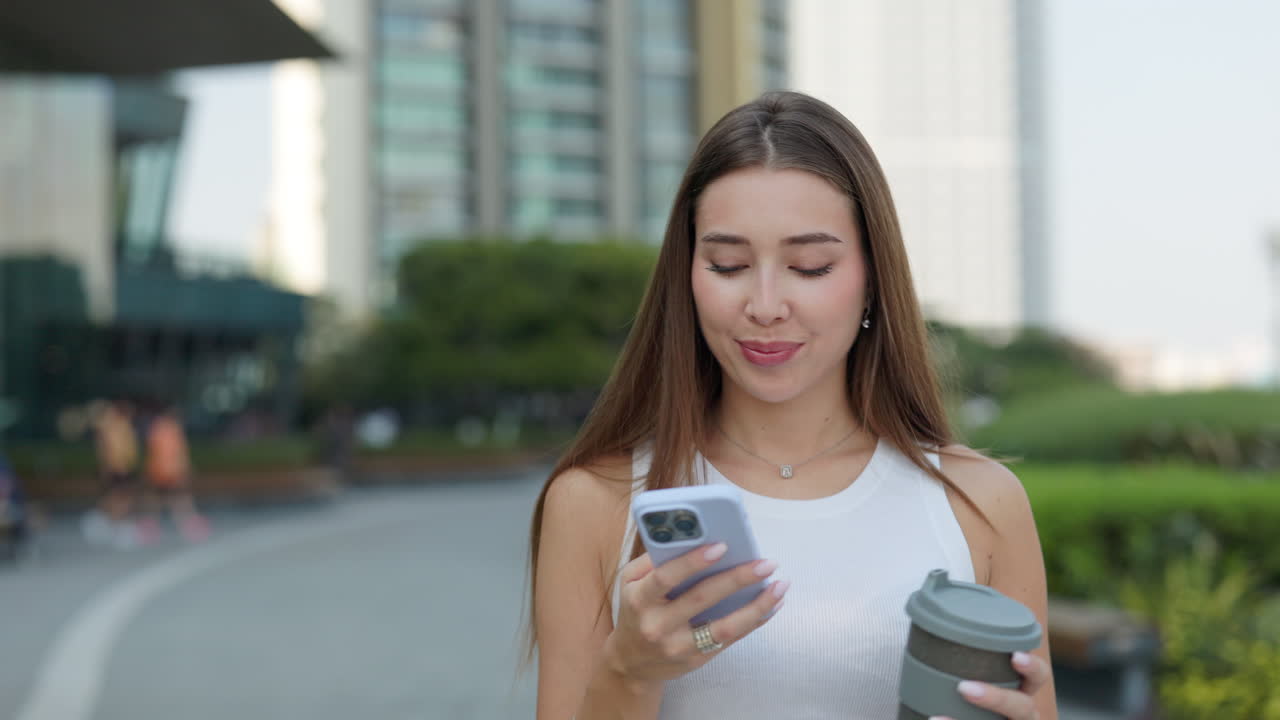 Woman using mobile phone in city