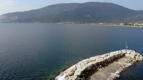 Aerial-forward-flight-from-over-breakwater-to-the-sea,-Turkey