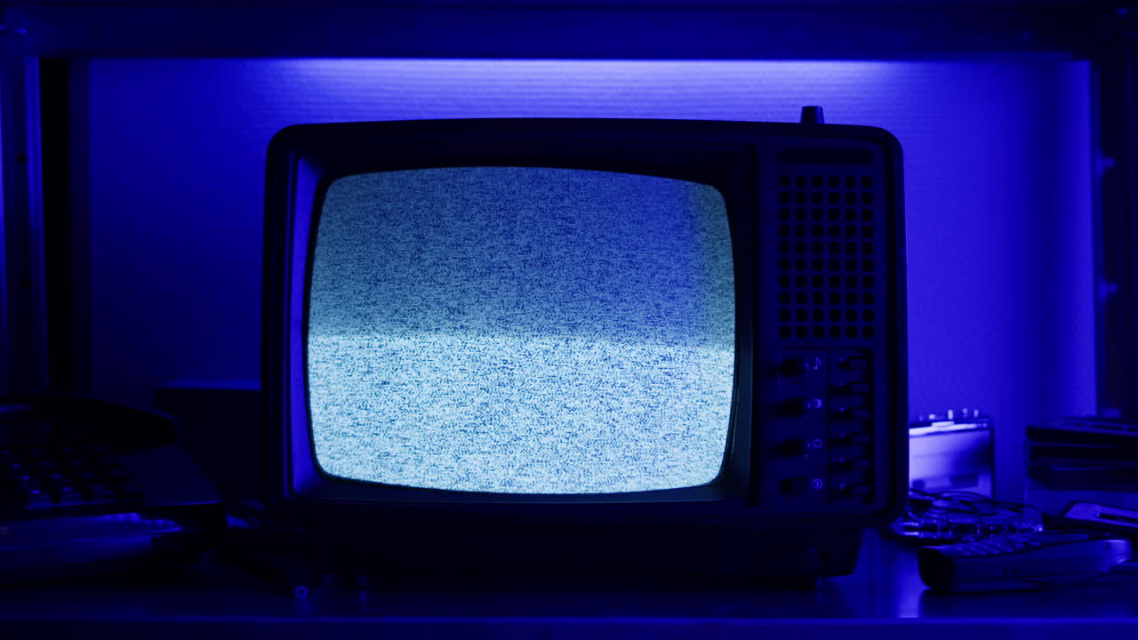 Retro TV, vintage television In a nostalgic setup, a retro TV displays grain on screen, scary halloween night device good for chroma key and green screen.