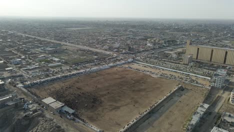 drone footage from traditional central asian sport "buzkashi" in which horse-mounted players attempt to place a goat or calf carcass in a goal, in balkh, afghanistan. march 21, ?2021