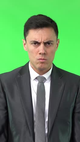 angry businessman pouting on green screen