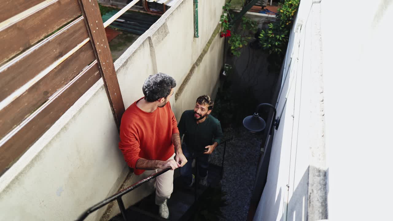 Two Men Walking Up Outdoor Stairs and Talking