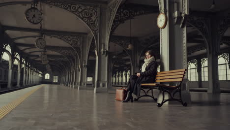 woman waiting at empty train station