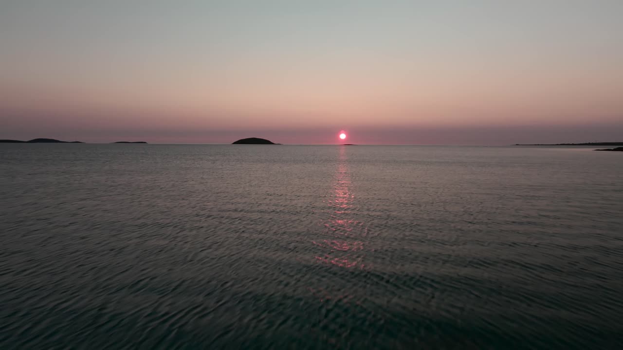 Forward moving drone shot of sunset from Scottish island