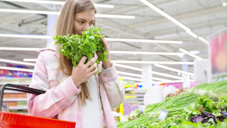 woman shopping for cilantro at a grocery store