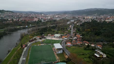 rio miño and oira soccer field in ourense, galicia, spain panoramic aerial establishing city