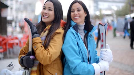 two gorgeous young brunette snowboarders