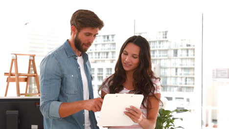 creative business people looking at clipboard