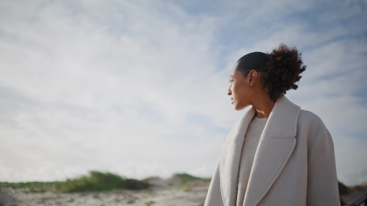 Girl hand stroking railings on beach. Pensive girl walking pier looking solution