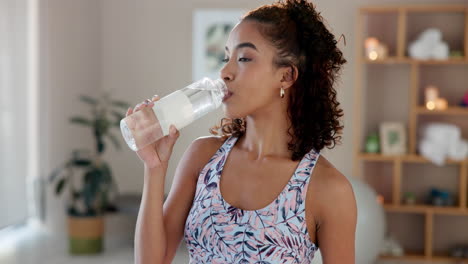 woman drinking water after exercise