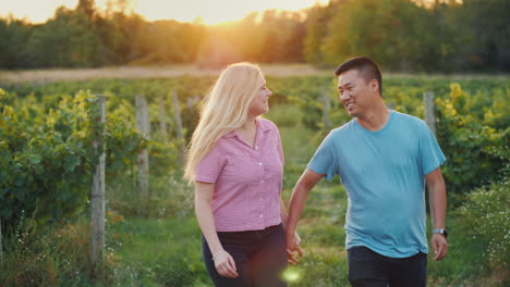 Happy-Multiethnic-Couple-Walking-In-The-Vineyard-Wine-Tasting-And-Tourism-Concept-4k-Video