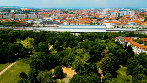 4k aerial drone video of the city park next to the train station in downtown erfurt, germany