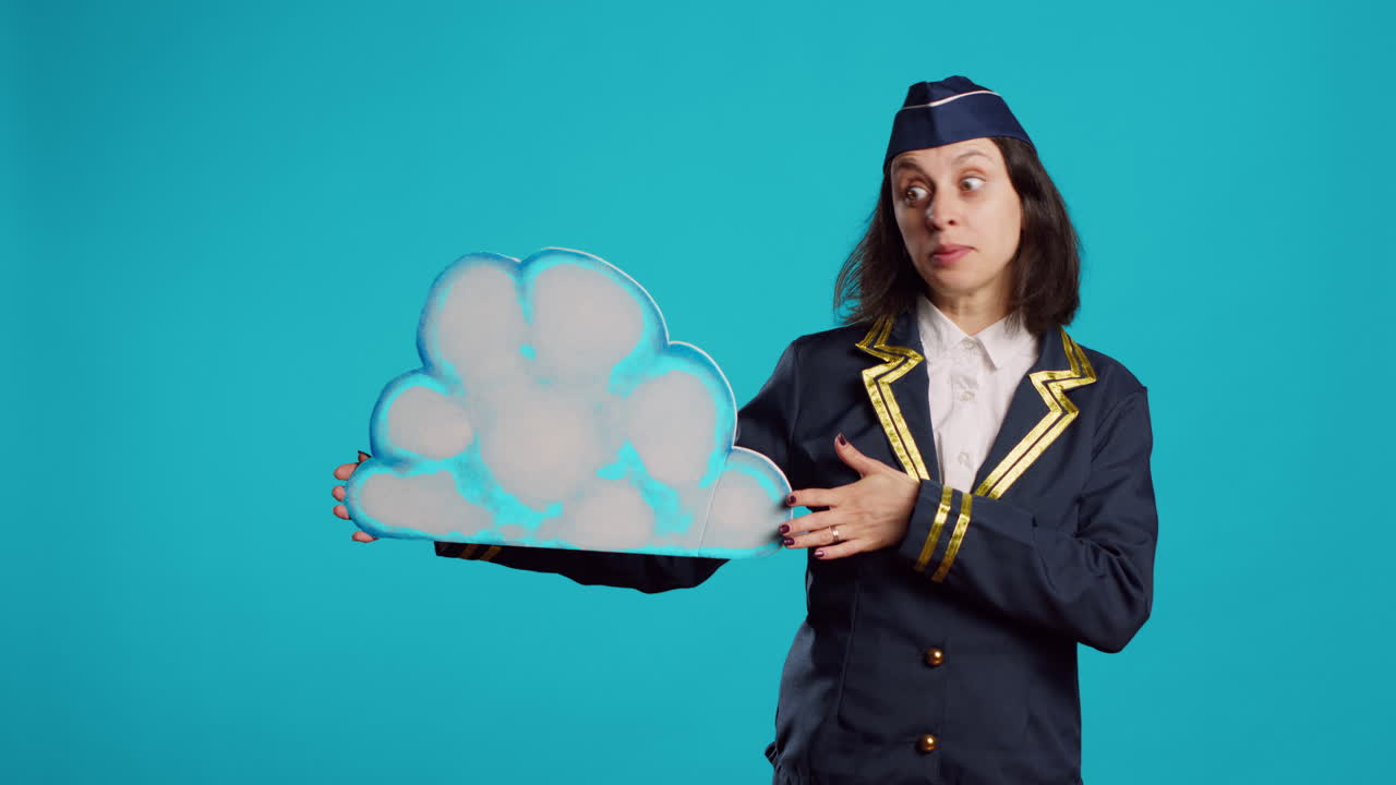 Young stewardess presenting cloud shape billboard
