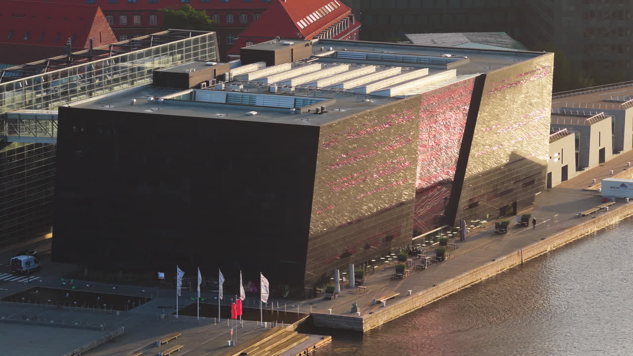 Aerial drone view of of the Black Diamond library reflecting golden light on its modern glass facade