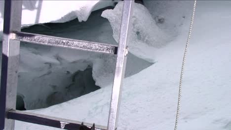 pov crossing ladder over deep crevasse