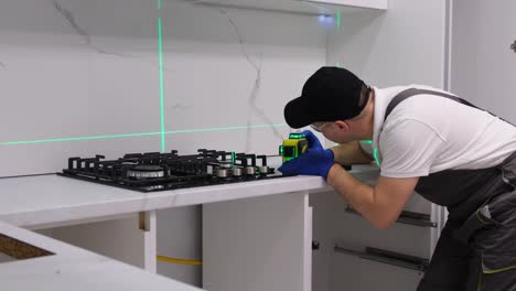 a professional master during the installation of kitchen furniture a professional master during the installation of kitchen furniture installation of modern highquality furniture accessories moving to a new apartment
