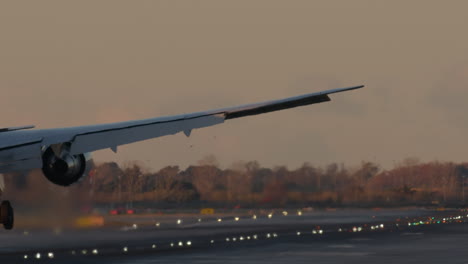 airplane landing at sunset