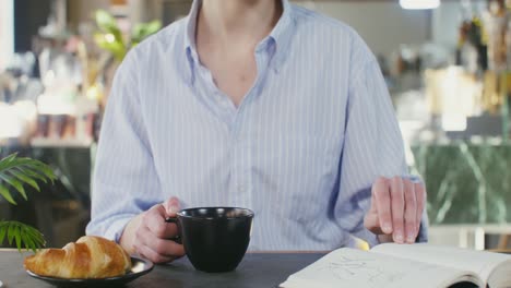 woman drinking coffee in a cafe