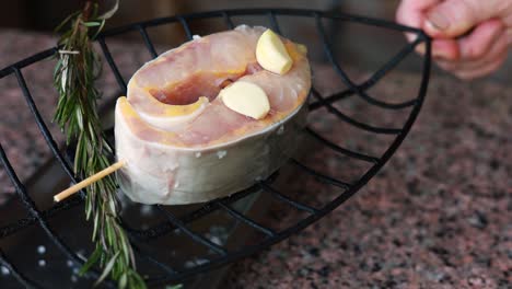 preparing grilled fish with rosemary and garlic