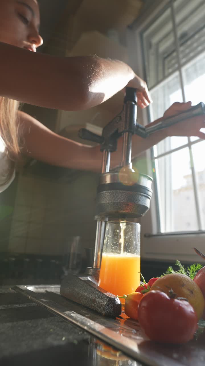 Woman Making Fresh Juice in the Kitchen
