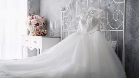 slow motion white wedding dress on bed near nightstand