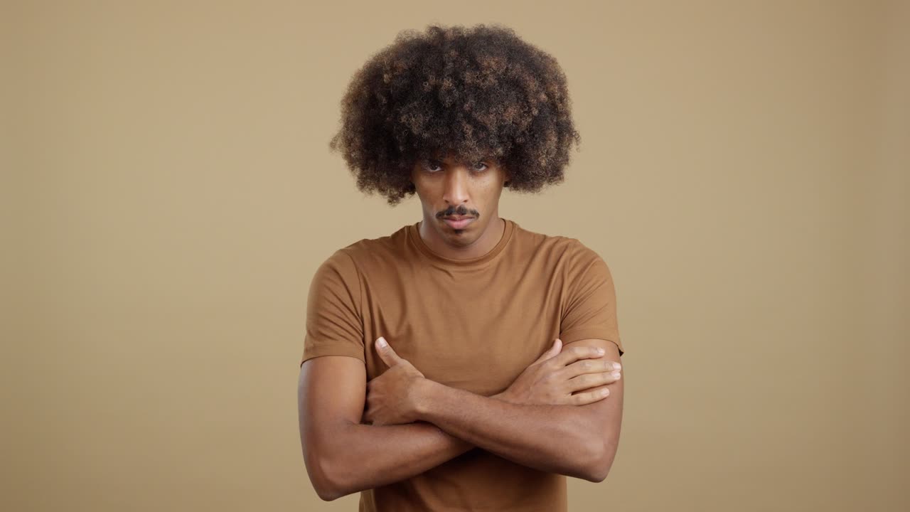 Serious man with an afro and mustache