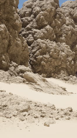 arid desert landscape with rugged cliffs and sandy terrain