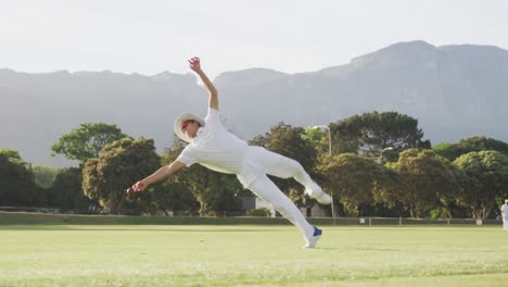 Cricket-player-catching-the-ball-on-the-pitch