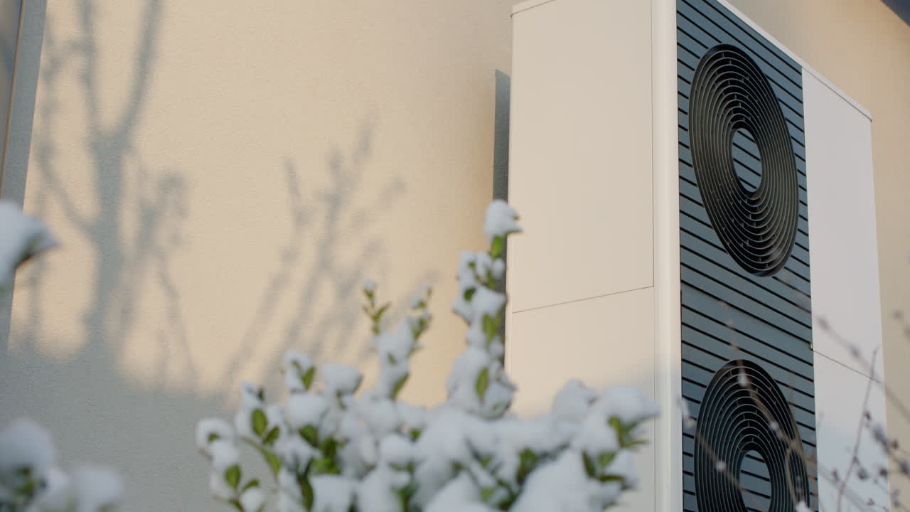 Exterior view of a modern heat pump on a house in winter