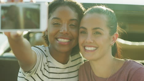 two young women taking selfies together