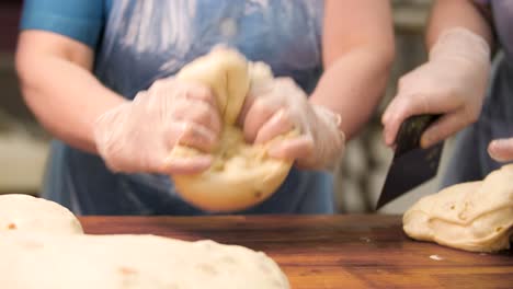 bakery worker kneading dough