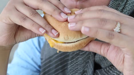 women hand holding beef burger top view ,